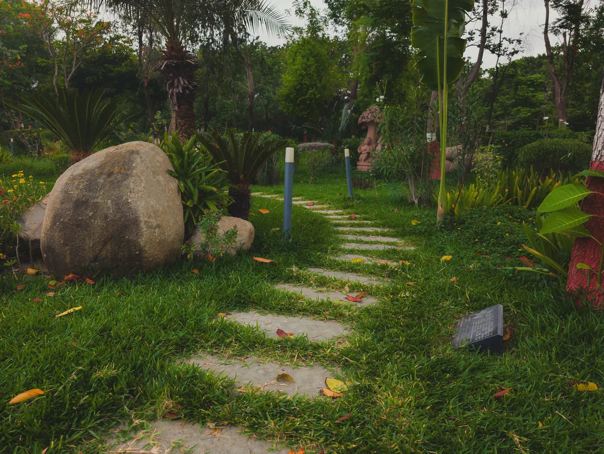 A stone pathway winding through deep planted borders